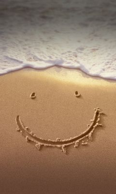 Lächelndes Gesicht im Sand